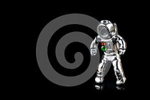 Steel astronaut figurine isolated on black