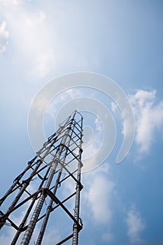 steel bar tie with wire to form concrete pole, blue sky background.