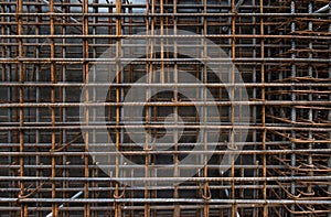 Steel bars reinforcement on construction site, vertical wall, background.