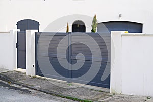 Steel big grey metal gate fence on modern house street