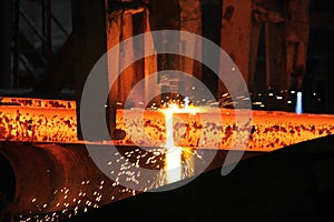 Steel billets at torch cutting in metallurgical plant. Metallurgical production, heavy industry, engineering, steelmaking