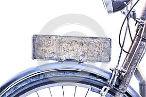 Steel blank rusty license plate on vintage bicycle isolated on white background