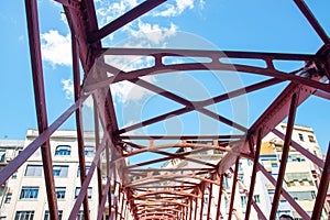 Steel bridge across the river near much houses,construction detail.