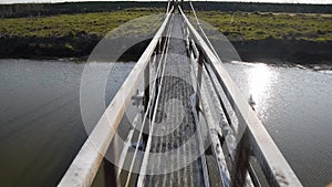 Steel bridge and gas pipeline through irrigation canal.