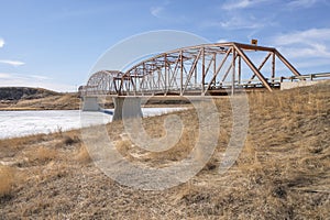 Steel Bridge over a Frozen Prairie River