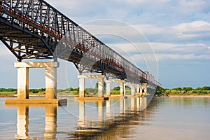 Steel bridge over the Irrawaddy river in Mandalay, Myanmar, Burma. Copy space for text.