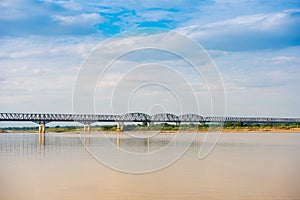 Steel bridge over the Irrawaddy river in Mandalay, Myanmar, Burma. Copy space for text.