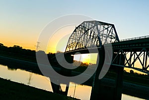 Steel bridge  over the Mississippi River at sunset Confluence Bike Trail Illinois