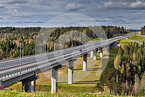 Steel bridge overpass on concrete piers, highway crosses Russian