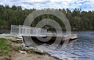 A steel bridge to a wooden pier for visitors to enter and dive into Eivindsvannet lake in Djupadalen recreational area