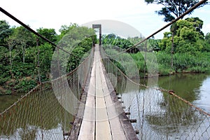 Steel cable bridge on the river