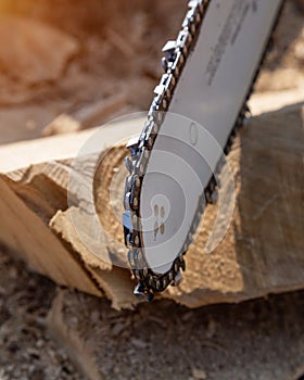 Steel chain chainsaw. sawing firewood outdoors