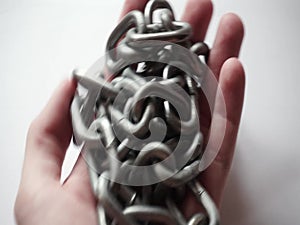 Steel chain in the hands of a man