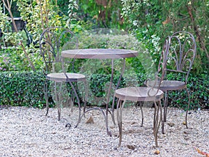 Steel chairs and table with wooden seats in the garden