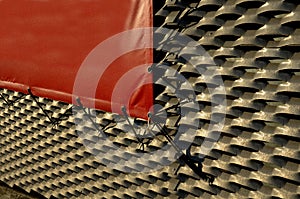 steel cladding of a building with a expanded metal lattice structure. galvanized gray nets protect the industrial building.