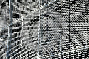 Steel cladding of a building with a expanded metal lattice structure. galvanized gray nets protect the industrial building. Blue s