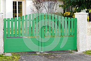 Steel classic green metal gate fence of house street view