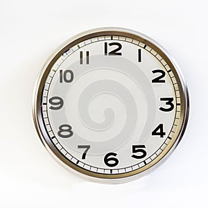 Steel clock with no hands on a white background