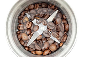 Steel coffee grinder with coffee beans isolated on white background