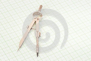 Steel compasses on a millimetre paper photo