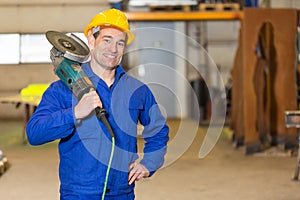 Steel construction worker posing with angle grinder