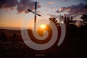 Steel cross on the top of the mountain Vtacnik during sunrise, Slovakia