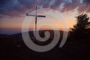 Steel cross on the top of the mountain Vtacnik during sunrise, Slovakia