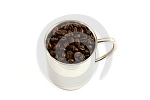 Steel cup full of coffee beans