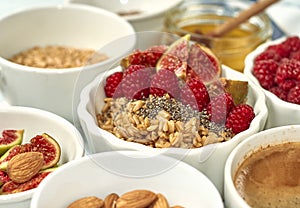 Steel cut oatmeal porridge with raspberry and nuts for breakfast