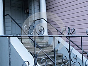 Steel decorative fence leading to residential steps and front door