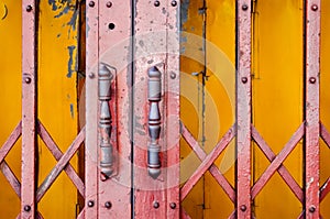 Steel door handles of the old red and yellow sliding door