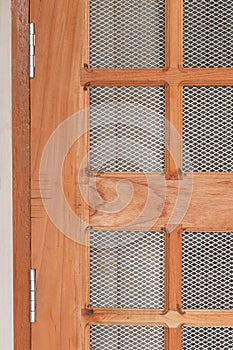 Steel door hinges fitted on wooden net grill door