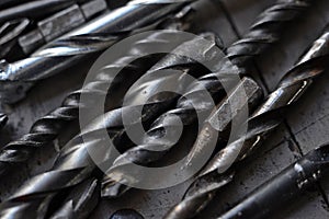 steel drill bits resting on a work bench