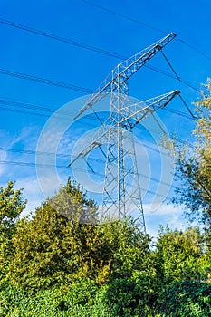 Steel electricity power tower construction in a nature landscape with blue sky