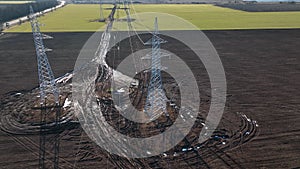 Steel erector workers strengthen a newly installed power line pylon