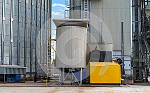 Steel factory containers on blue sky. Agricultural tank of fuel. exterior of elevator.