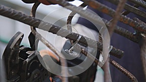Steel fixers connecting steel rods for concrete reinforcement