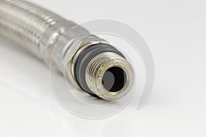 steel flexible hydraulic hose close up in studio.