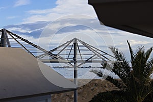 Steel frame of a beach umbrella on the winter season in the Mediterranean coast Italy, Europe