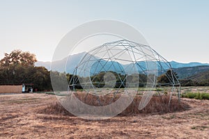 steel frame of a geodesic dome is built on nature. Such a frame has a large load-bearing capacity and wind resistance