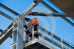 Steel frame workshop is under construction against a blue sky