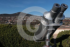 Steel free to use tower viewer binocular scope placed on Nitra castle, with cityscape of Zobor hill and settlements under it.