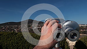 Steel free to use tower viewer binocular scope placed on Nitra castle, with cityscape of Zobor hill and settlements under it.