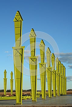 Steel girder shed construction with blue sky background in industrial field.