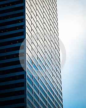 Steel and glass building and cloudy sky