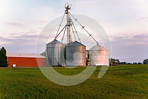 Steel grain bins at sunset