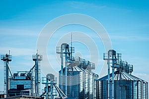 Steel grain silos against the background of the sky