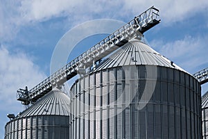 Steel grain storage silos with a conical bottom can be used for various purposes. Industrial facilities of feed and flour mills photo