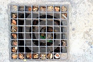 Steel grates, old steel manhole covers on cement or road surfaces