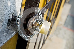 Steel grating closed by padlock photo